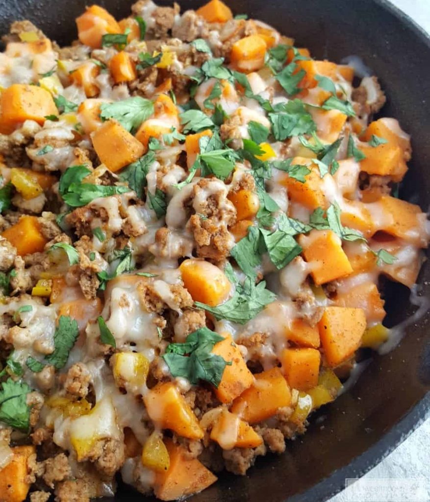 turkey and sweet potato hash in a cast iron skillet